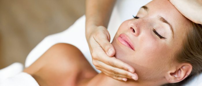 young-woman-receiving-head-massage-spa-center