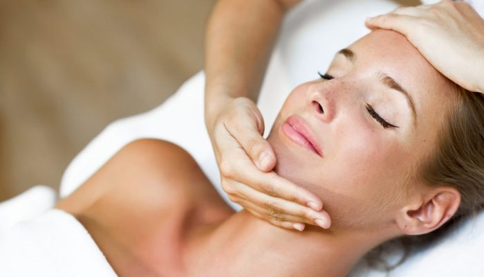 young-woman-receiving-head-massage-spa-center